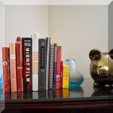 D43. Piggy bank and glass vase bookends. 